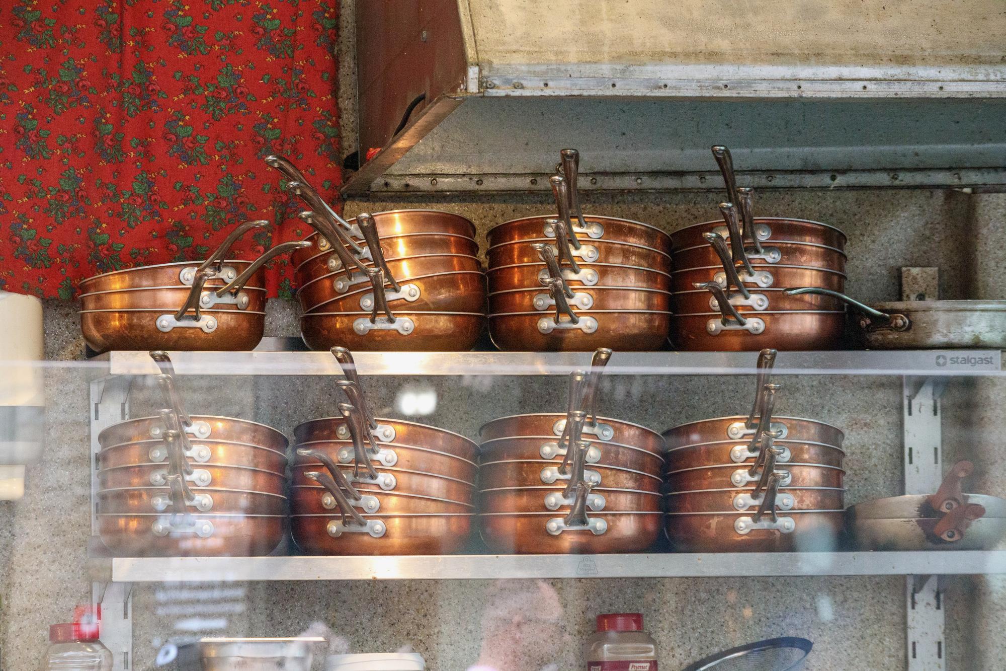 Interior of an elegant culinary studio with copper pans